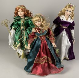 Three Beautifully Dressed Porcelain Dolls In Formal Dresses With Metal Stands
