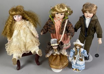 Six Porcelain Girl & Boy Dolls Of Various Sizes Including A Roller Skating Doll