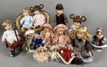 Many Small Porcelain Little Girl Or Baby Dolls Including A Doll In A Radio Flyer Wagon
