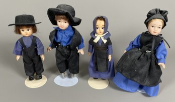 Set Of Four Porcelain & Plastic Dolls Of Amish People On Metal Stands