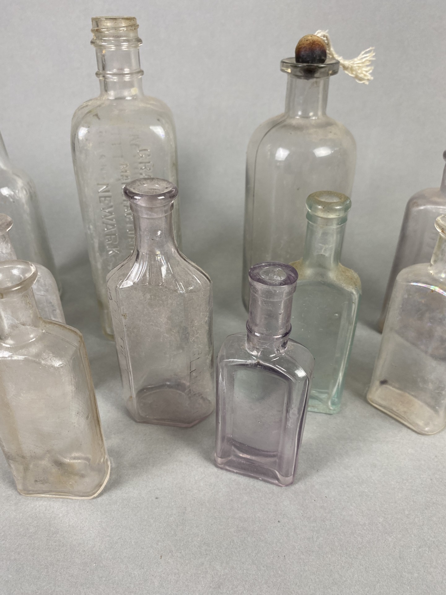 Many Vintage Glass Bottles In Different Shapes & Brands Including Gray