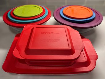Pyrex Glass Kitchen Collection Featuring Covered Baking Dishes And Colorful Lidded Bowls