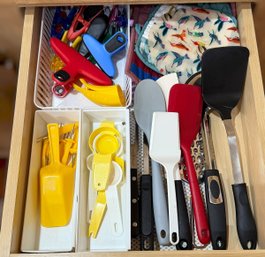 Collection Of Various Cooking Utensils Including Spatulas, Peelers, Measuring Cups, And Knives