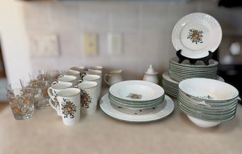 Set Of Mikasa Holiday Season Dinnerware And Glassware Featuring Embossed Holly And Colorful Holiday Motifs