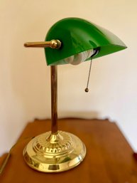 Classic Green Bankers Desk Lamp Featuring A Brass Stand And A Traditional Pull Chain