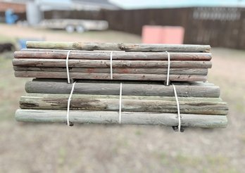 Bundles Of Pressure-treated, Round Wood Fence Posts