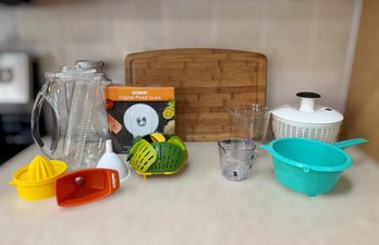 Collection Of Various Kitchen Gadgets And Tools Including Cutting Board, Juicers, And Digital Food Scale
