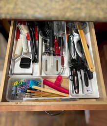 Assortment Of Kitchen Utensils And White Drawer Organizers