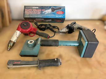 Tools For Carpet Installation Faturing A Knee Kicker, Staple Gun & Industrial Heat Gun