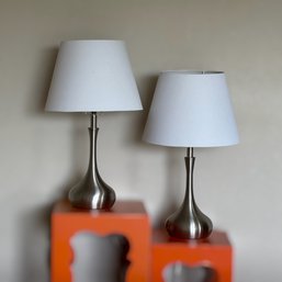 Contemporary Brushed Metal Table Lamps Featuring Sculptural Teardrop Bases And White Shades