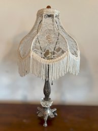 Vintage Victorian-style Table Lamp Featuring A Brass And Crystal Base With An Ivory Lace Shade And Fringe Trim
