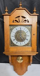 Decorative Wooden Wall Clock With A Pendulum And Roman Numerals