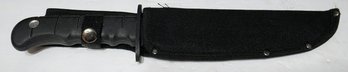 Appears To Be A Modern KA-BAR 1213 Black Fighting Knife With A Kraton Handle In A Cloth Sheath