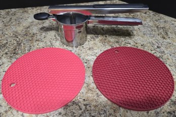 Pair Of Rubber Trivets And A Stainless Steel Potatoe Ricer