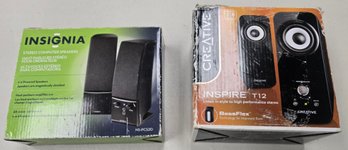 Two Sets Of Computer Speakers In Their Packaging