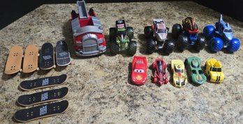 Group Of Toy Trucks And Skateboards