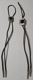 Two Vintage-style Bolo Ties, Featuring Black Braided Cords With Wear