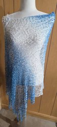 Handmade Crochet Or Knit Shawl Wrap Featuring A Gradient Blue And White Color Scheme