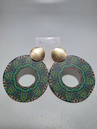 Boho-style Earrings Feature Large Wooden Discs Printed With A Colorful Mandala Pattern And Topped With Texture