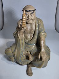 Depict An Arhat Holding A Small Pagoda Ceramic Figurine