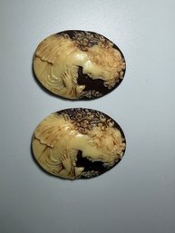 A Cream And Brown Resin Antiqued Woman With Bird Resin Cameo