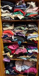 Several Shelves Of Womens Clothing Including Tops And Bottoms (FF)