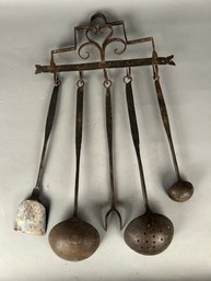 Antique Iron Utensils On Rack
