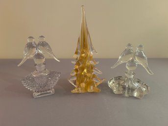 Two Perfume Bottles With Bird Stoppers And A Glass Tree