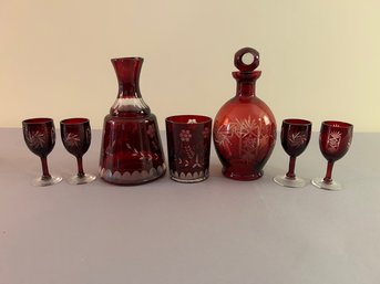 Two Cranberry Cut Glass Decanters And Several Glasses