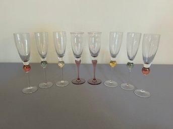 Eight Champagne Flutes With Colored Stems
