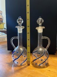 Glass Cruets With Stoppers Featuring Decorative Blue Glass Accents.