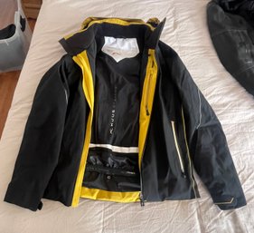 A Kjus Black And Yellow Insulated Ski Jacket.