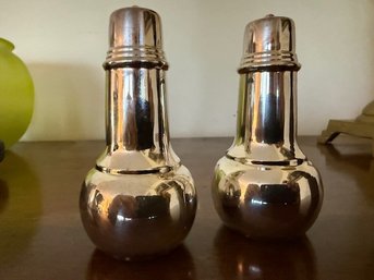 A Set Of Silver Plate Salt And Pepper Shakers