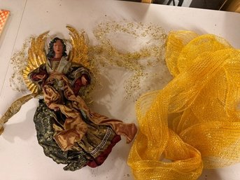 Angel Figurine And Gold Sheer Material