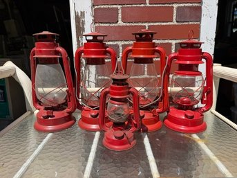 A Collection Of Five Assorted Red Kerosene Lanterns