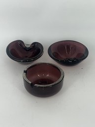 A Group Of Three Amethyst Glass Ashtrays