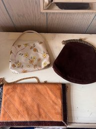 A Group Of Three Hand Bags Suede, Floral And Camel With Gold Chain