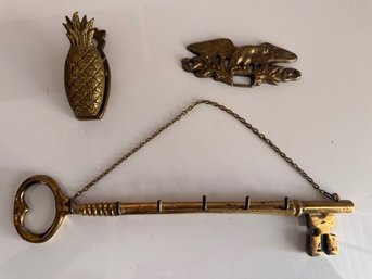 A Group Of Brass Accessories, Pineapple Clip, Wall Key Organizer And Eagle