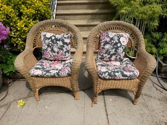 A Pair Of Wicker Arm Chairs With Cushions