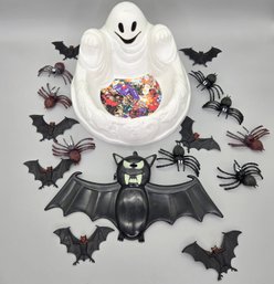A Ghost Candy Bowl With Plastic Bats And Spiders