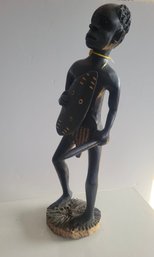Hand Carved African Figure Holding A Weapon And A Sheld