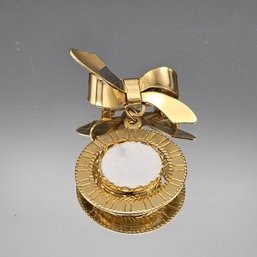 Gold-toned Bow Brooch With A Circular Pendant.