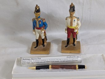 Two Cast & Painted Metal Soldier Pens & Hoders Together With A Fine Bubinga Sierra Turned Wood Pen