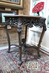 Antique French Inspired Round End Table With An Inlaid Design On A Hexagonal Top And Hand Carved Mahogany Legs