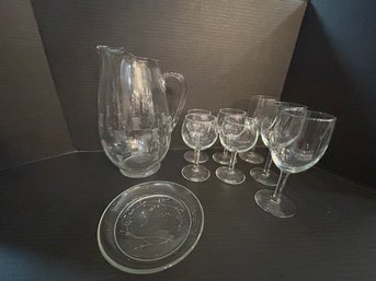 Glass Pitcher , Small Saucer And 7 Wine Glasses