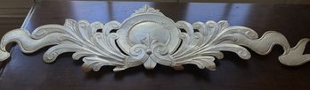 Decretive Metal Wall Plaque Is 47' Long And Off White In Color Hangs Flat Against A Wall