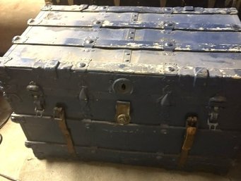 Antique Steamer Trunk Featuring Brass Hardware And Leather Strapping