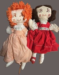 A Pair Of Handmade Folk Art Cloth Dolls With Yarn Hair And Embodied Face Features
