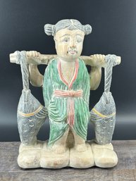 Hand Carved Wooden Figure Carrying A Pole With Fish