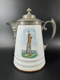 ANTIQUE ENAMELWARE COFFEE POT WITH STATUE OF LIBERTY
